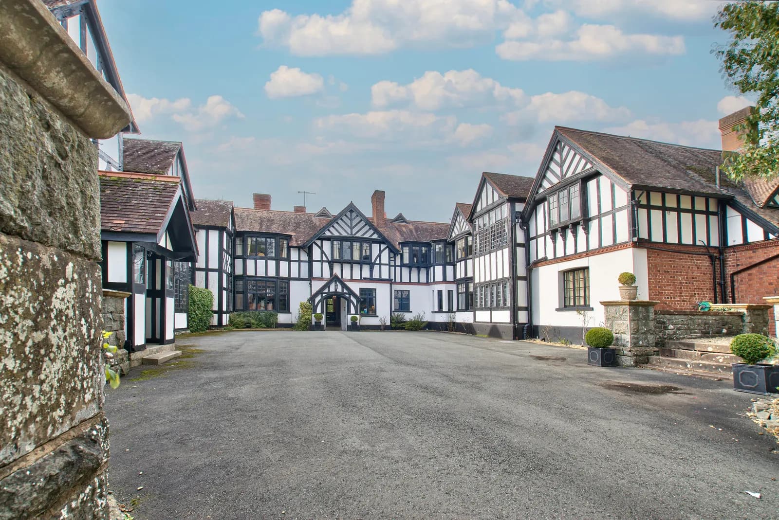 Caer Beris Manor, a black-and-white timbered manor house at the end of its drive
