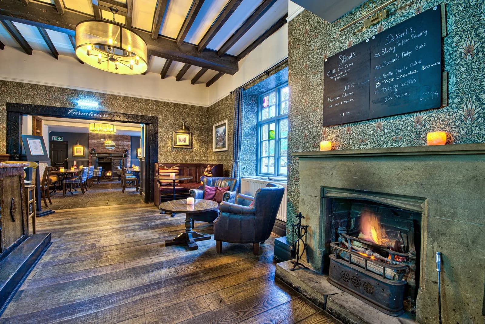 The bar at The George at Piercebridge, with beams, an open fire and a chalkboard menu