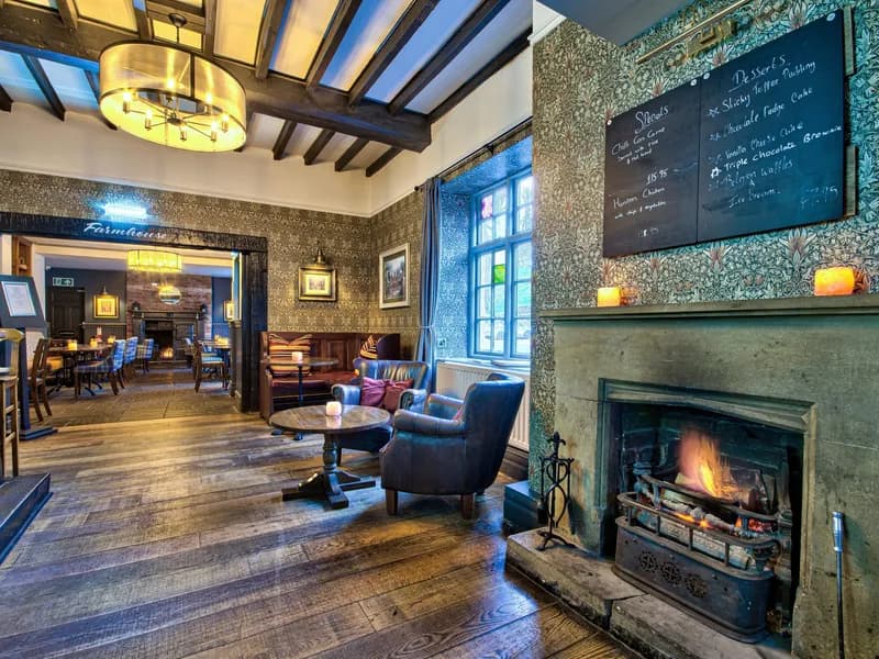 The bar at The George at Piercebridge, with beams, an open fire and a chalkboard menu