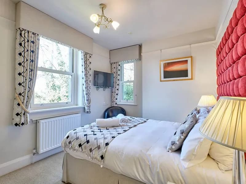 Room Three at Grassington Lodge with a tall red headboard