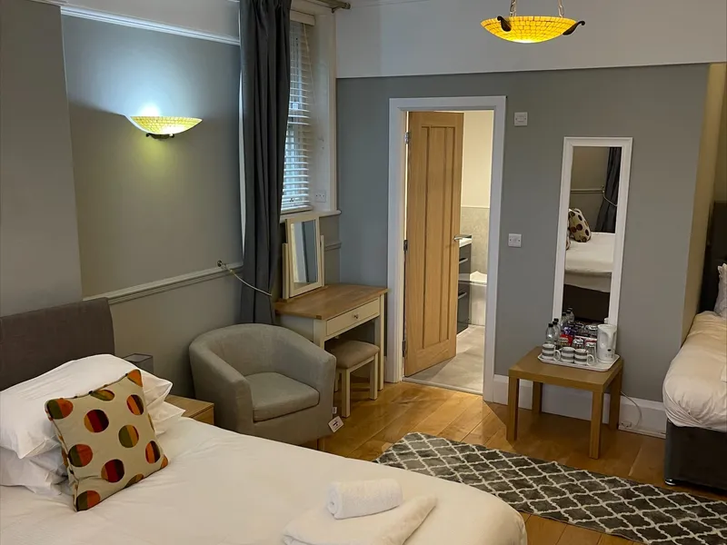 The family room at Grassington Lodge with grey walls and a single bed